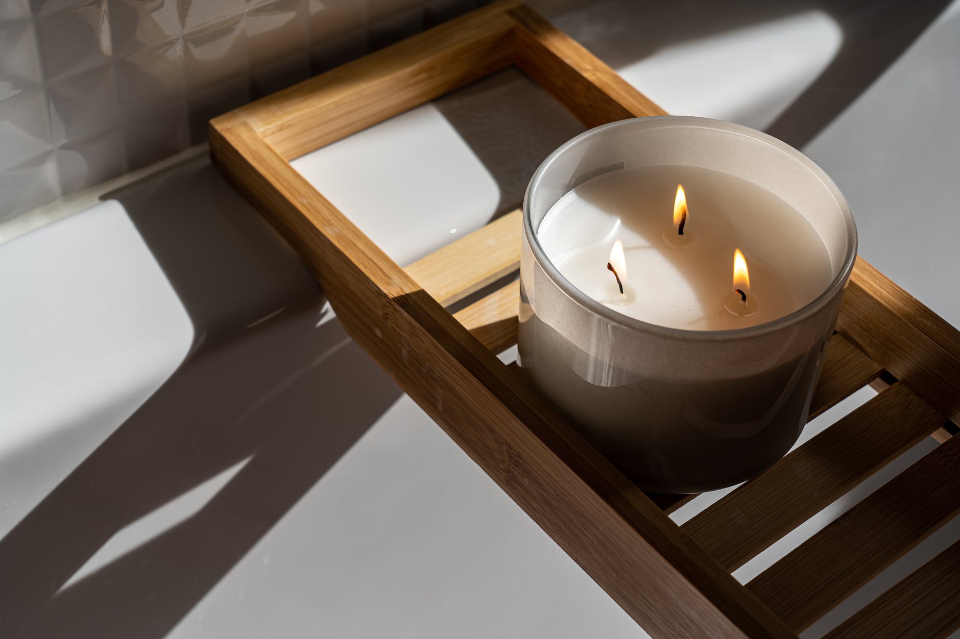 photo of candle on wooden tray